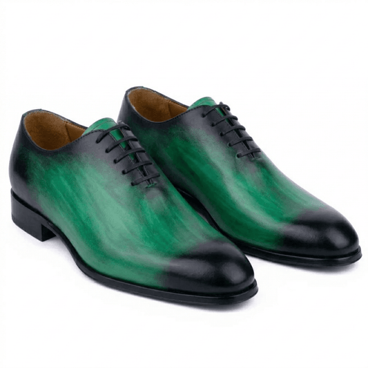 Bold emerald green and black hand-painted leather Oxford shoes for men with a dramatic smoky patina and sleek wholecut-style silhouette.