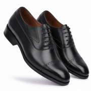 Black leather Oxford shoes crossed side view