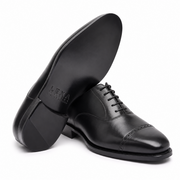 Rear view of black leather Oxford shoes showing the heel design