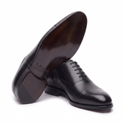 Sole view of black leather Oxford dress shoe