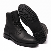Black leather ankle boot showing textured rubber sole