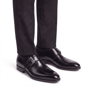 Black monk strap shoes worn with formal trousers