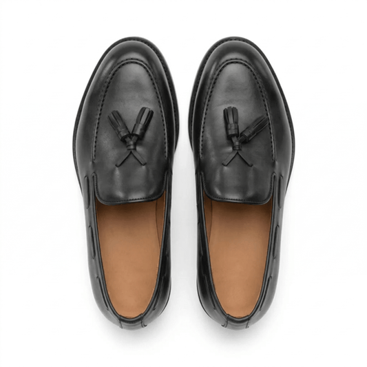 Top-down view of premium black leather tassel loafers for men, featuring a handcrafted moc-toe design and smooth leather finish on a clean white background.
