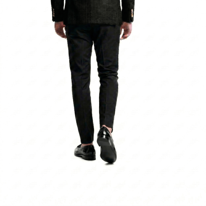 Rear view of polished black leather loafers for men, showcasing a sleek slip-on design and durable sole, paired with formal slim-fit trousers.