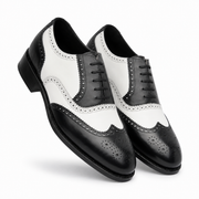 Pair of black and white leather wingtip brogue shoes for men