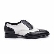 Side view of black and white leather dress brogue shoes