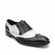Side profile of black and white leather wingtip brogue shoe