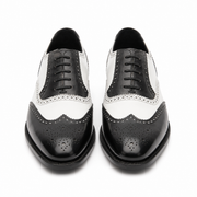 Front view of black and white leather brogue shoes for men