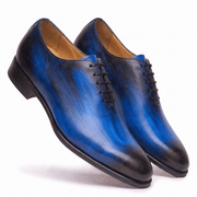 Angled view of blue leather Oxford shoes showing the soles
