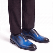 Man wearing blue leather Oxford shoes with formal trousers