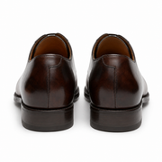 Rear view of dark brown leather Oxford shoes showing the heel design