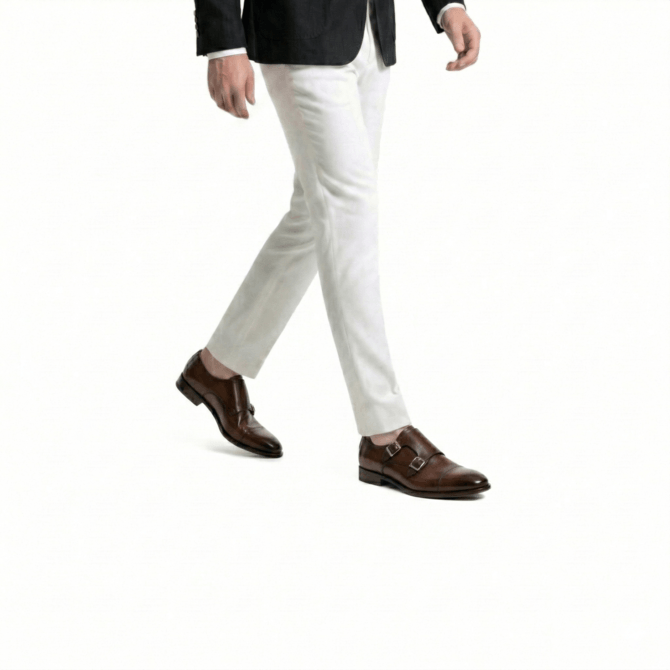 Men walking in brown double monk strap leather shoes with cream trousers stylish formal outfit premium dress shoes