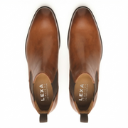Overhead top-down view of men's brown leather Chelsea boots.