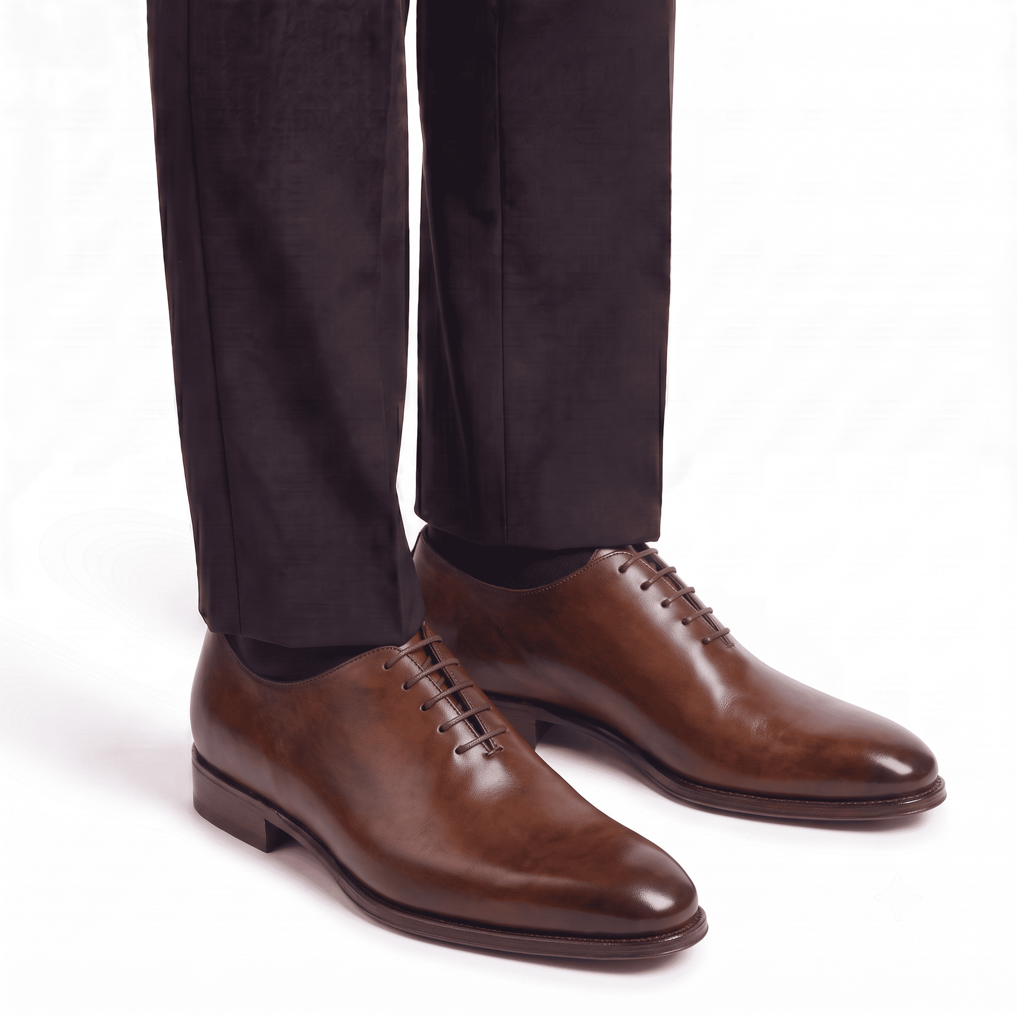 Brown leather Oxford shoes worn with formal trousers