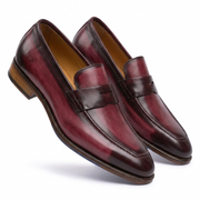 Front view of a pair of burgundy leather penny loafers for men