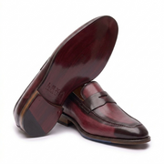 Burgundy leather penny loafers showing the leather sole and heel