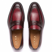 Top view of burgundy leather penny loafers for men