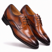 Pair of brown leather Oxford shoes angled view