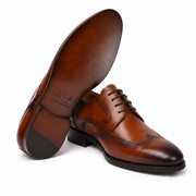 Brown Oxford shoes showing soles and heels