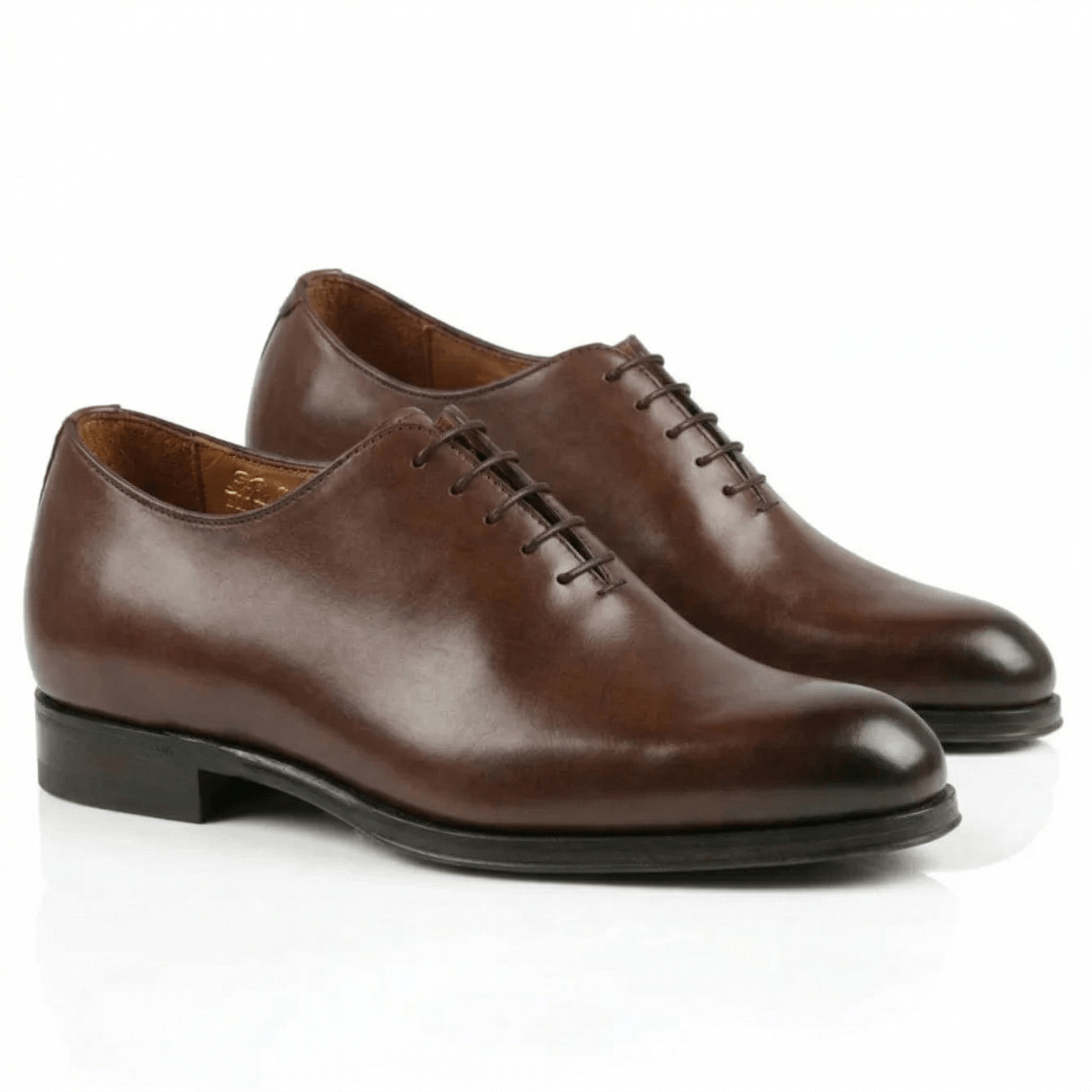 Sleek dark brown leather Oxford shoes for men featuring a hand-burnished almond toe and a minimalist wholecut-style design.