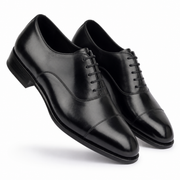 Angled view of black leather dress shoes for men