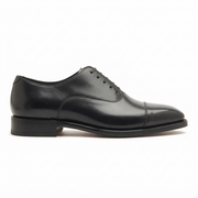 Black leather dress shoe side profile