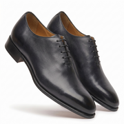 Pair of black leather Oxford shoes showing side profile