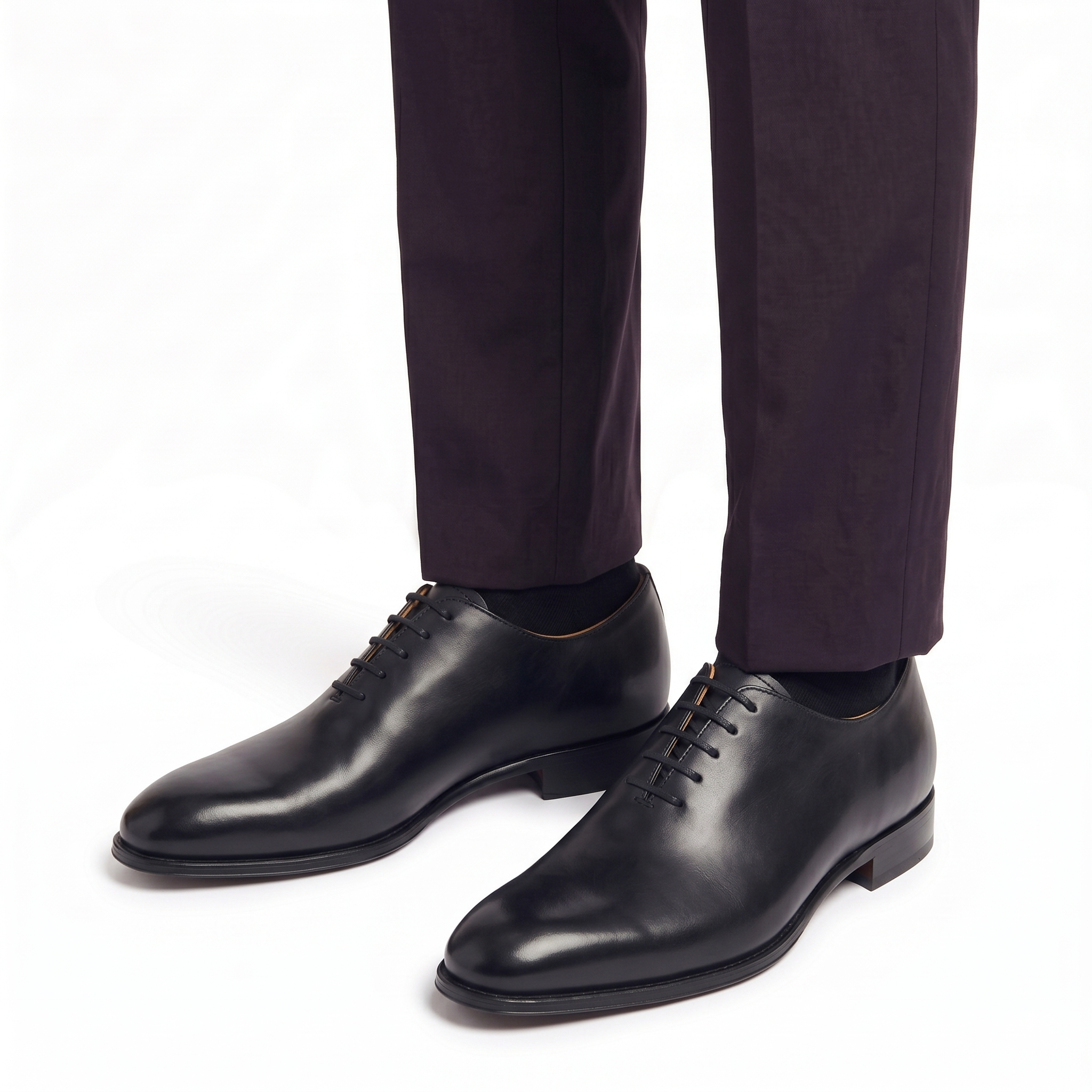 Black leather Oxford shoes worn with formal trousers