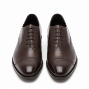 Dark brown leather Oxford shoes showing the outsole and heel design