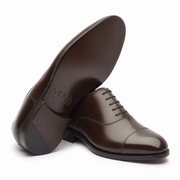 Open view of dark brown leather Derby shoes showing interiors