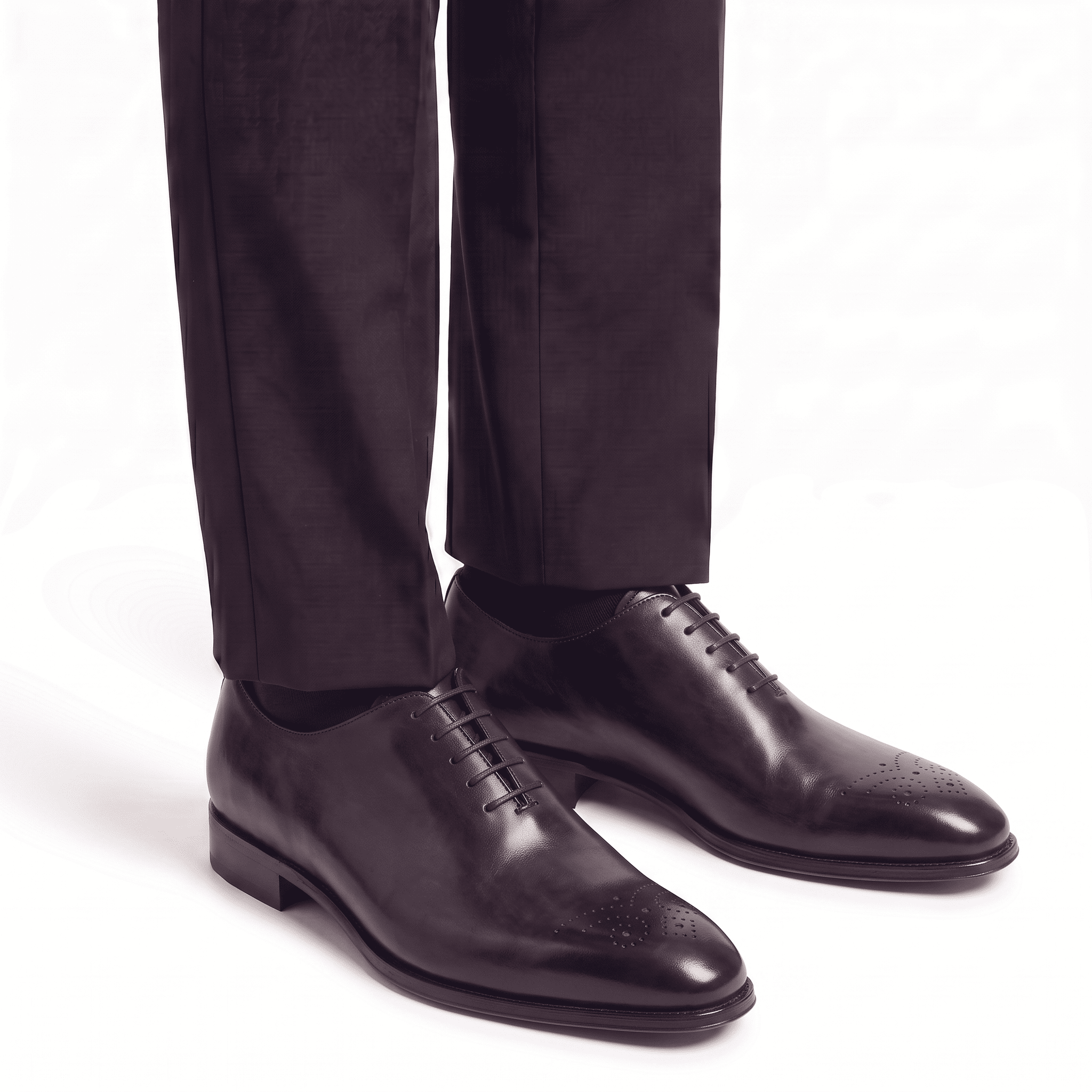 Dark brown leather dress shoes worn with formal trousers