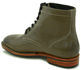 Side view of forest green leather boots with Goodyear welt stitching and rugged design