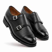 Angled view of black leather double monk strap shoes