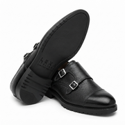 Black double monk strap leather shoes showing sole