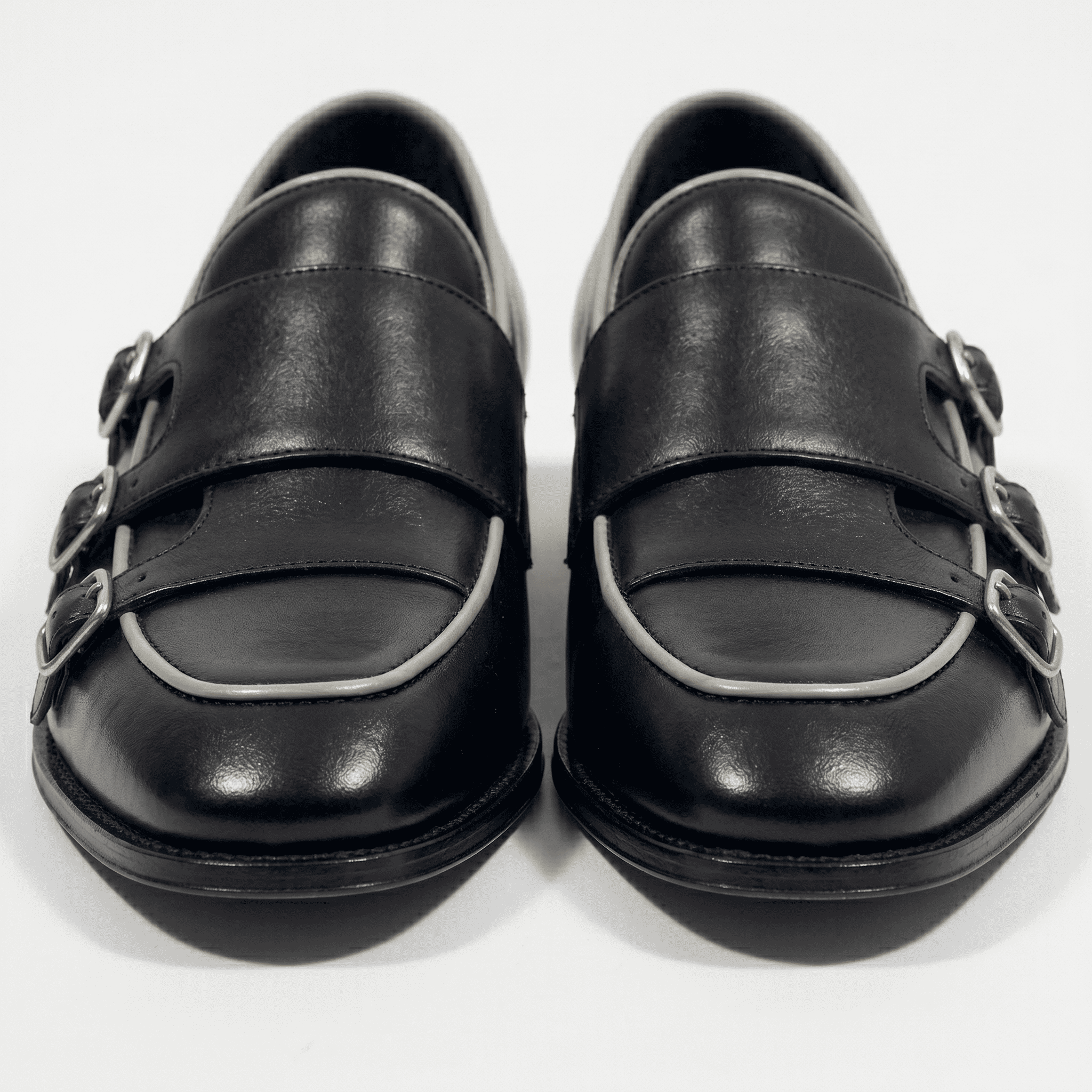 Front view of black leather triple monk strap loafers for men