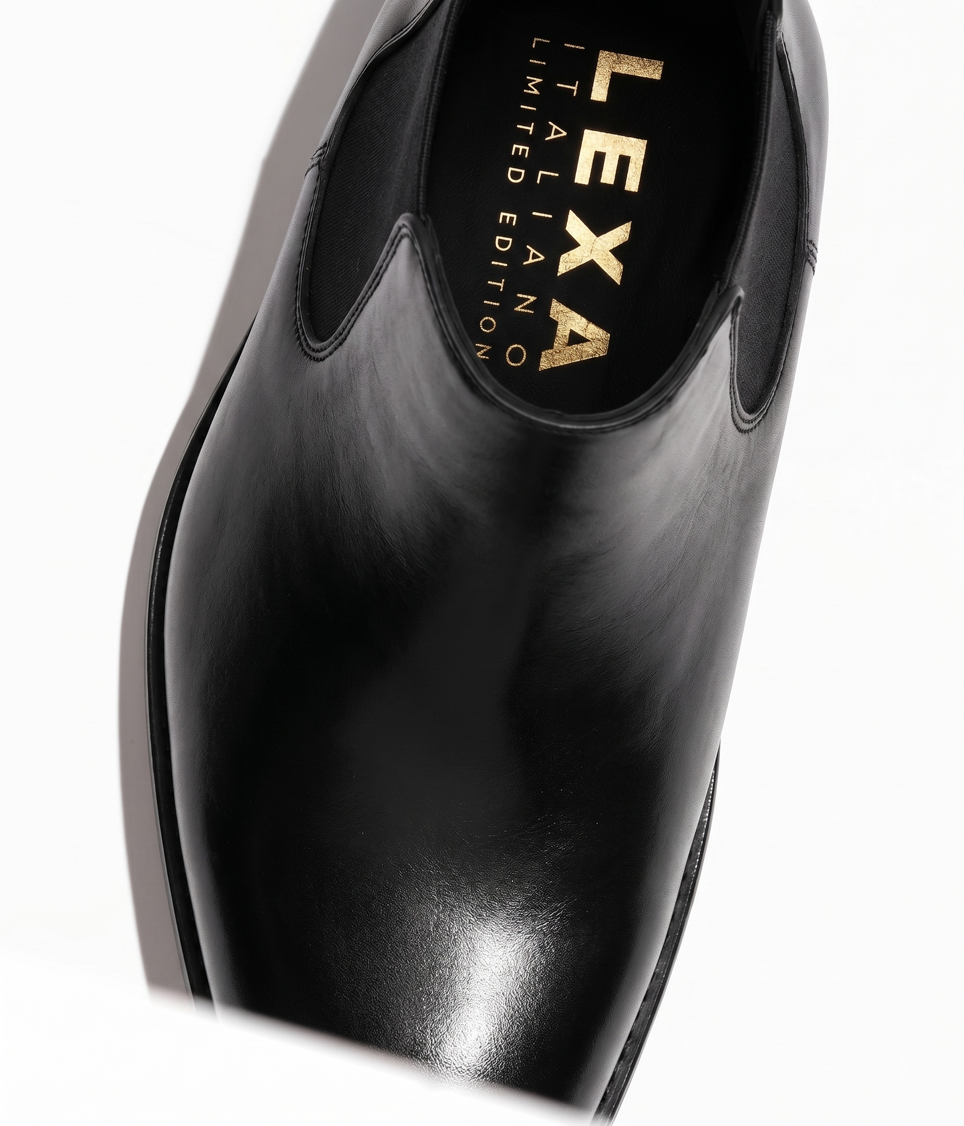 Black leather Chelsea boots pointed toe close-up