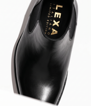 Black leather Chelsea boots pointed toe close-up