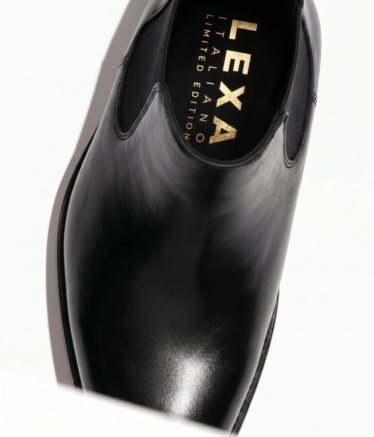 Black leather Chelsea boots pointed toe close-up