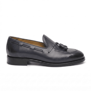 Side view of black leather horsebit loafers showing low heel