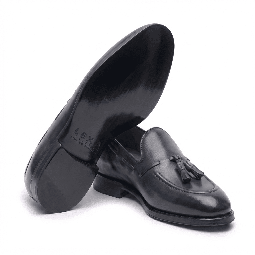 Angled top view of black leather horsebit loafers for men