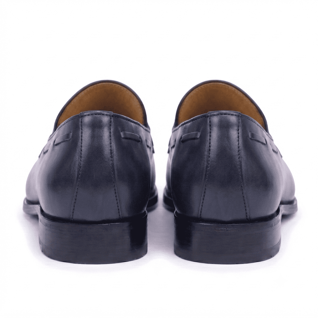 Back view of black leather horsebit loafers showing heel and leather finish