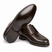 Angled view of dark brown leather Derby shoes showing the soles