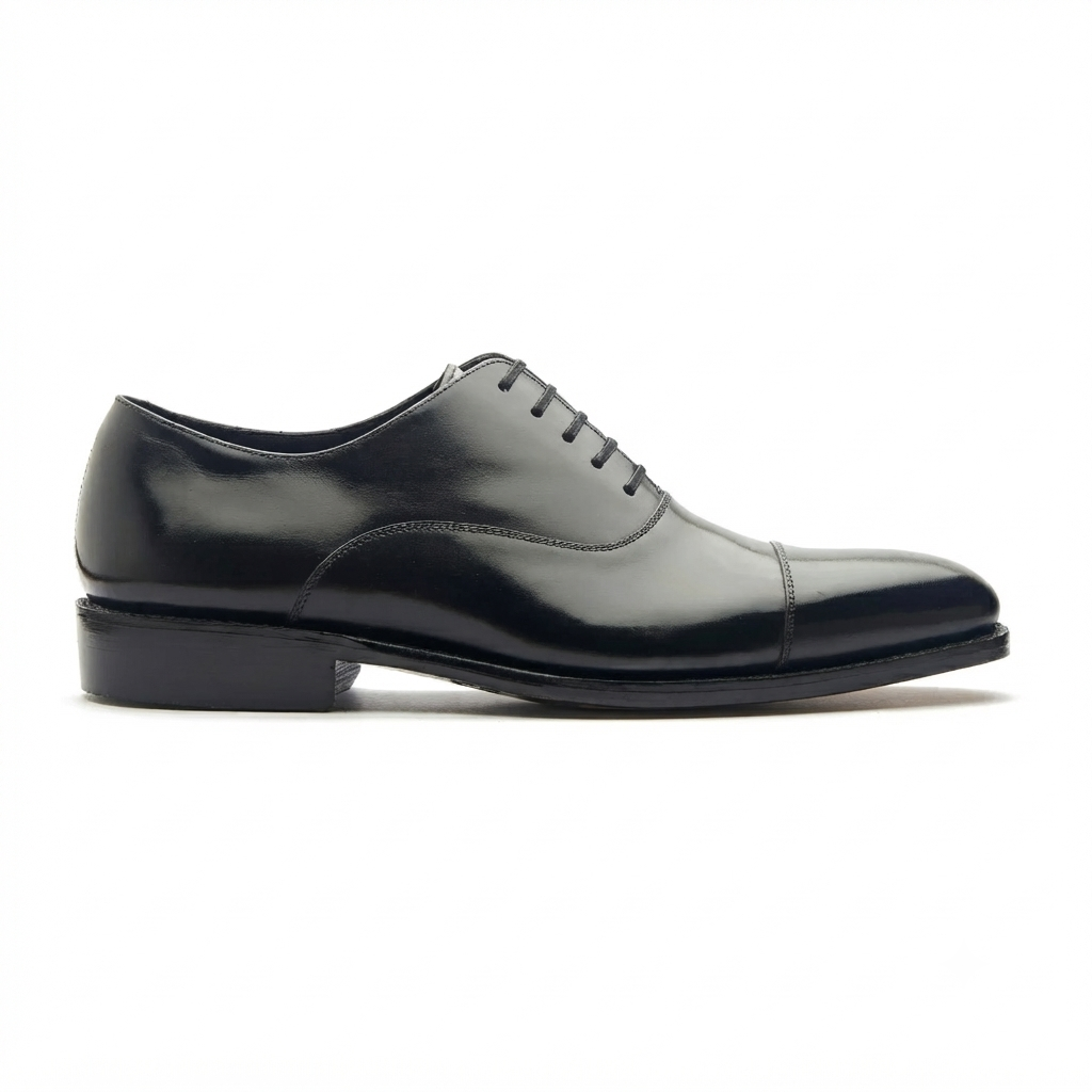 Black leather Oxford shoes showing the outsole and heel design