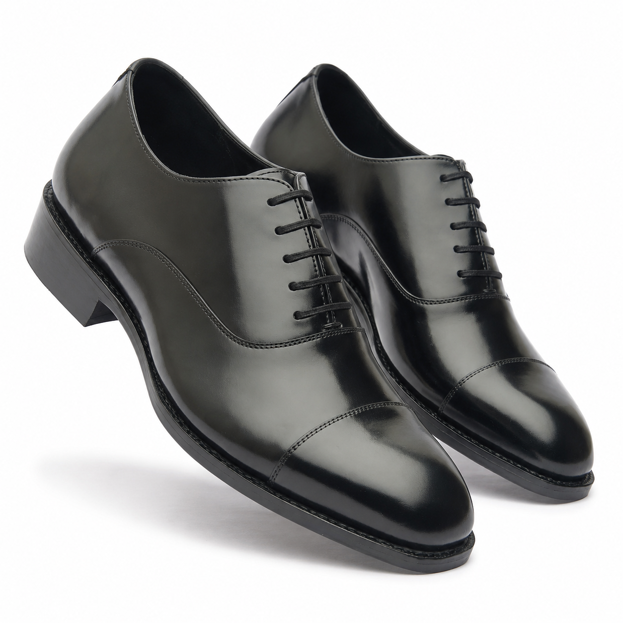 Pair of black leather Oxford shoes shown from a three-quarter angle
