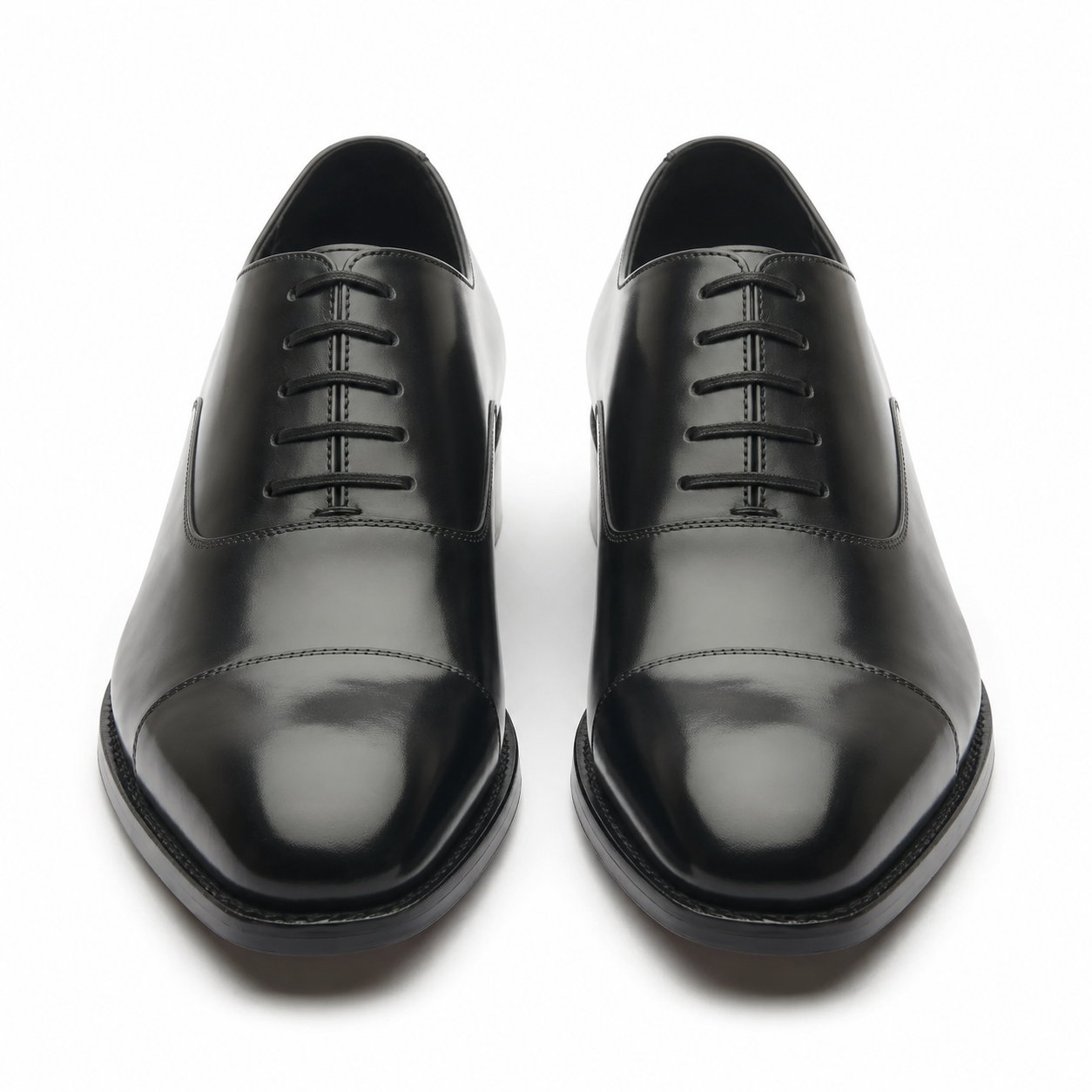 Black leather Oxford shoes for men showing the rounded toe and polished leather