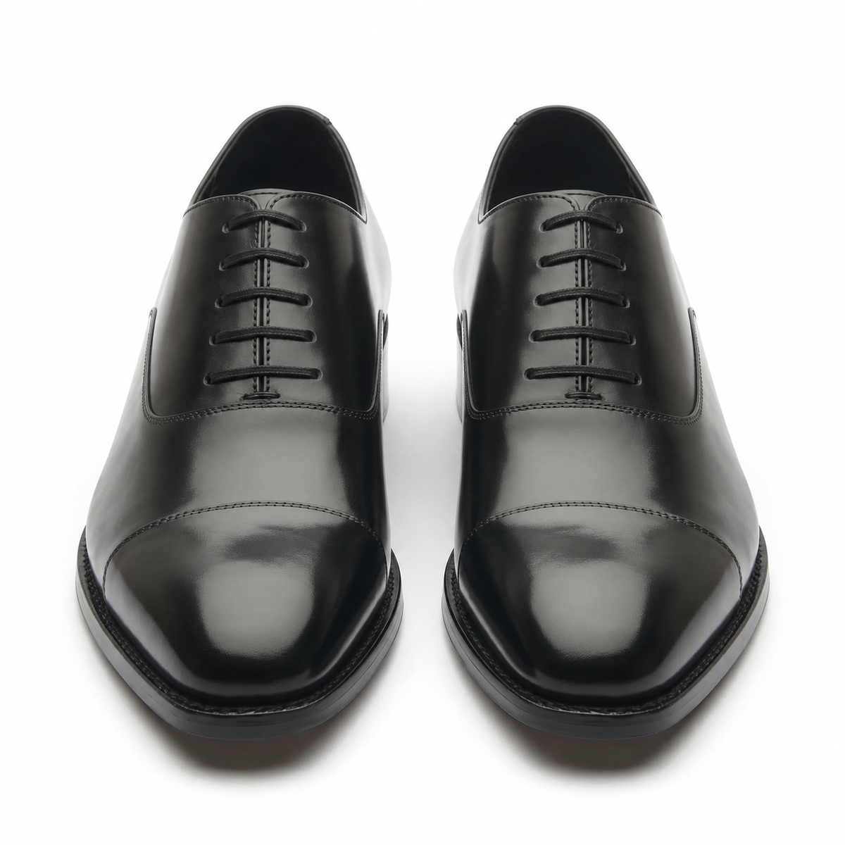 Black leather Oxford shoes for men showing the rounded toe and polished leather
