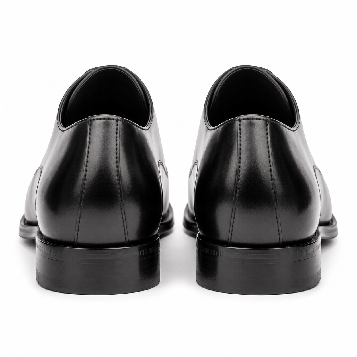 Pair of black leather Oxford shoes showing the heel and rear construction