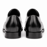 Pair of black leather Oxford shoes showing the heel and rear construction