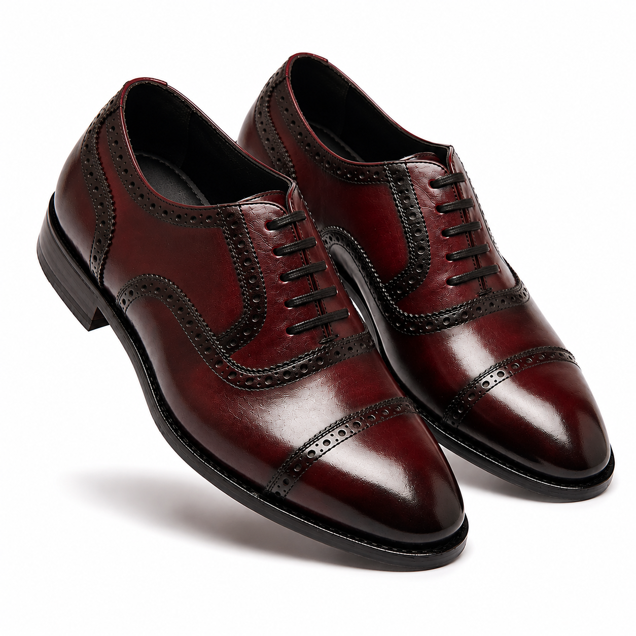 Burgundy leather brogue Oxford shoes shown together from an angled side view