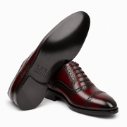 Burgundy leather brogue Oxford shoe showing the black leather sole and heel